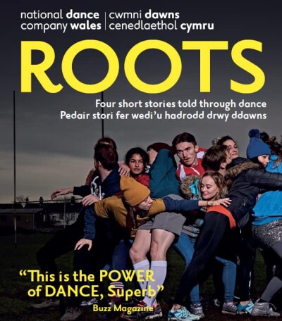 A poster of NDCWales Roots tour with the title ROOTs in yellow at the top and an image of a group of dancers squashed together in a scrum of bodies